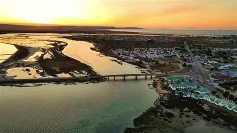 Sunset over the Berg River mouth and bridge at Velddrif, with Port Owen and the sea beyond